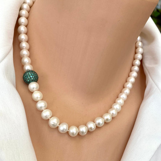 Pearl necklace featuring lustrous freshwater pearls and a vibrant green CZ bead, handcrafted in Canada.