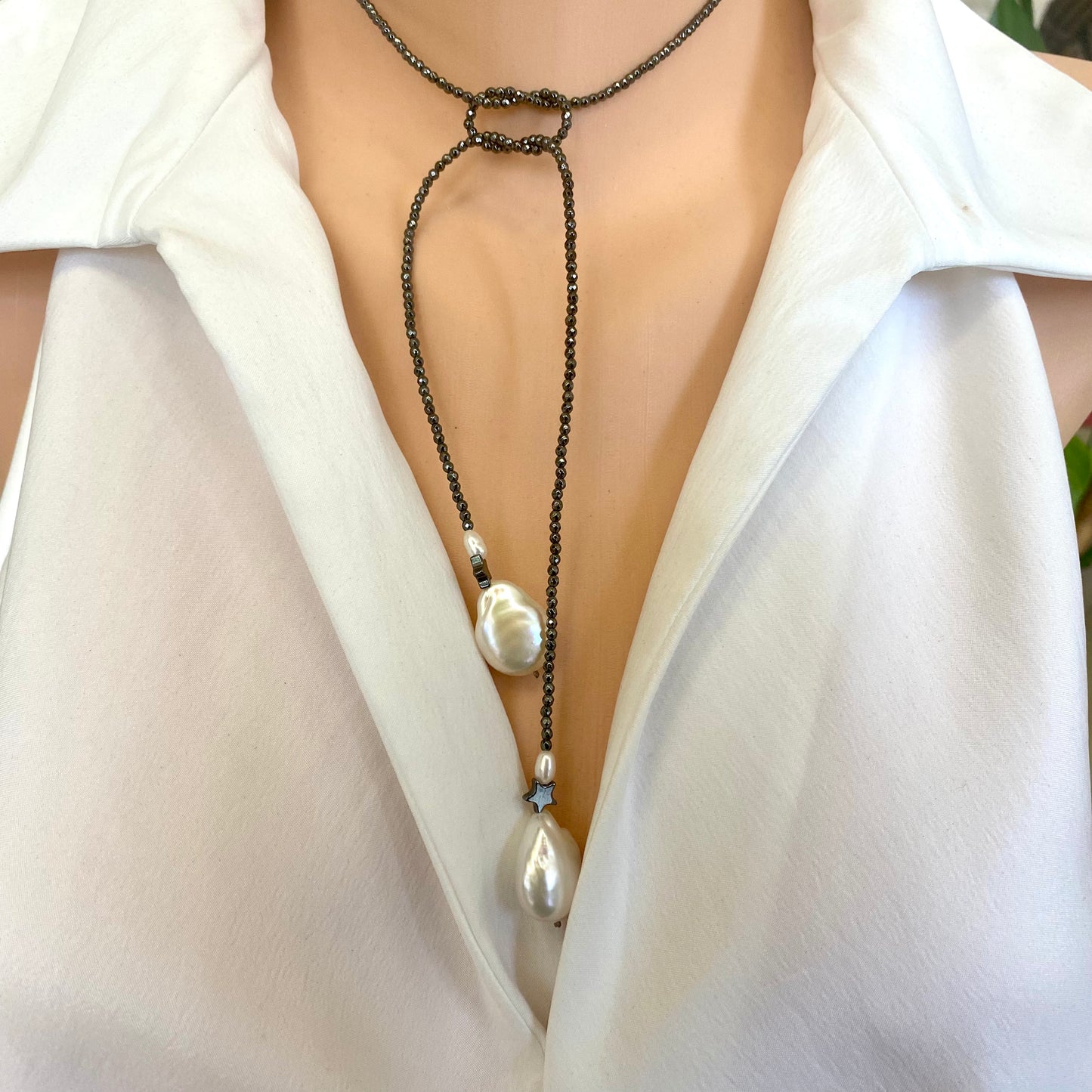 Hematite baroque pearl lariat necklace worn on model showing adjustable lariat styling