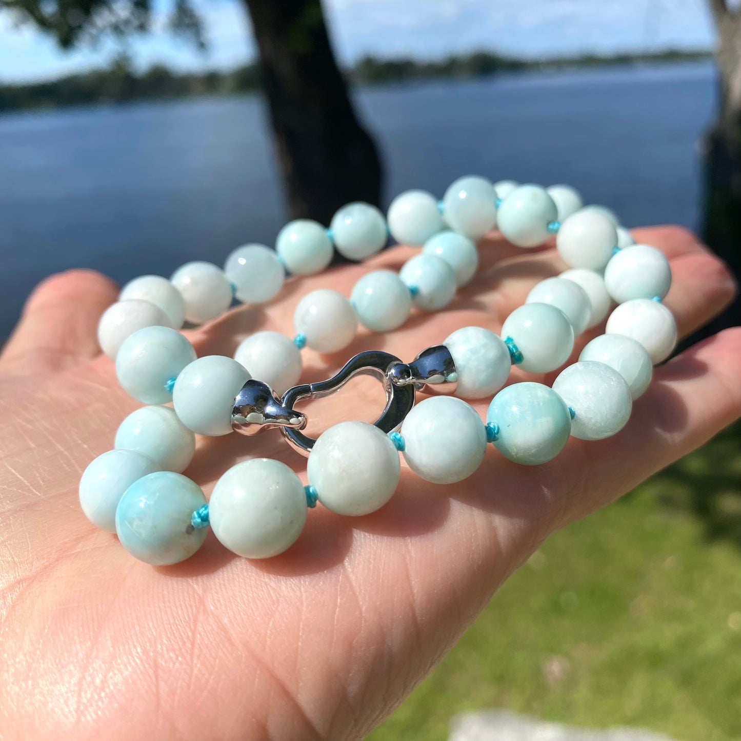 Light blue hemimorphite candy necklace photographed outdoors highlighting bead color and size