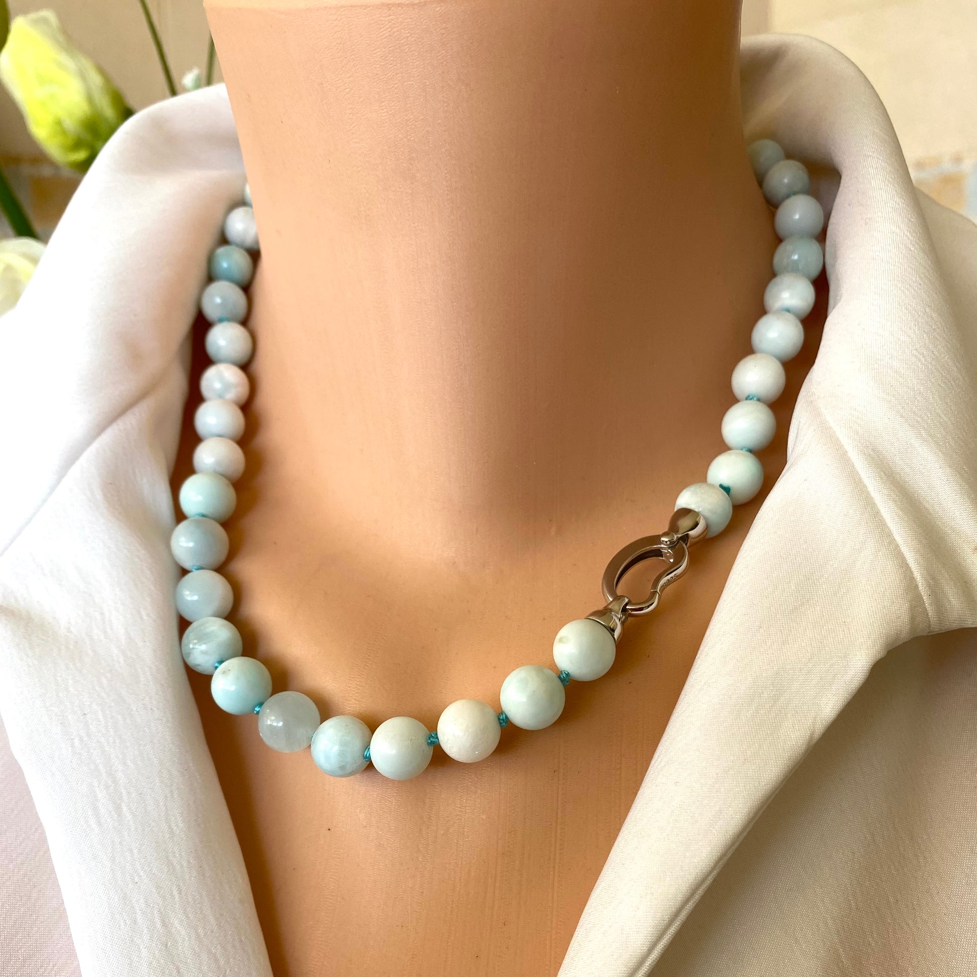 Light blue hemimorphite candy necklace styled at the neckline with hand-knotted beads
