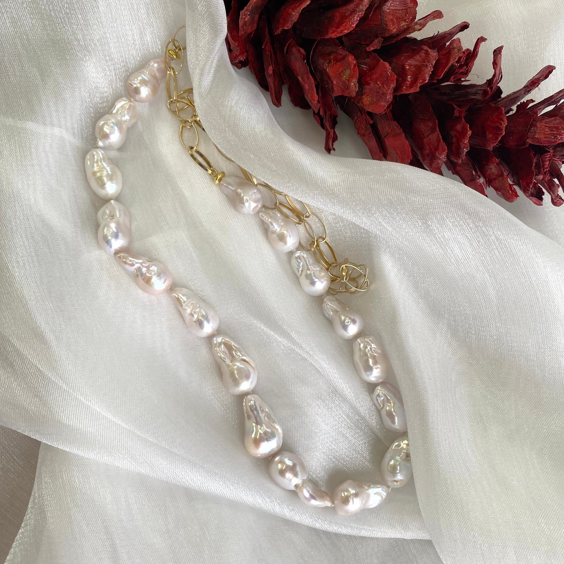 Detailed product shot of baroque pearl gold chain necklace — freshwater baroque pearls and gold vermeil chain displayed on white background