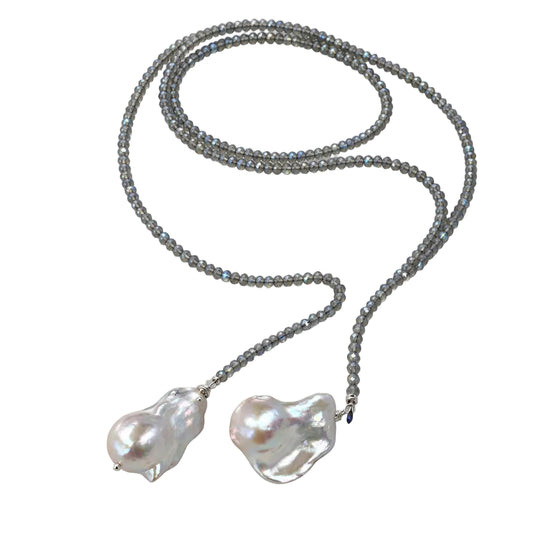 Labradorite and Baroque Pearl Necklace displayed on a silky surface with an abalone shell.