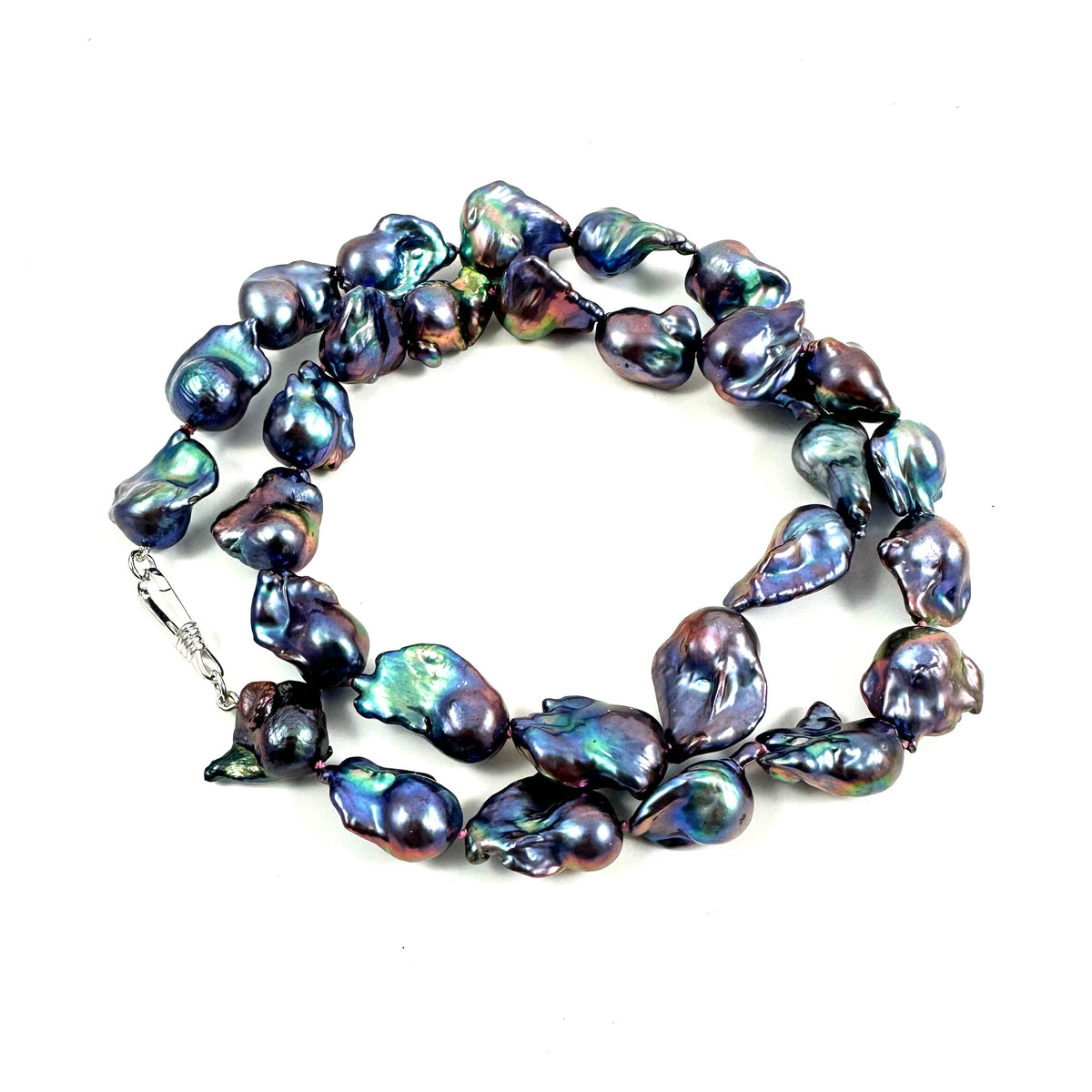 A strand of baroque freshwater pearl necklace with an iridescent, multicolor sheen of blue, green, and purple, displayed on a clean white background.