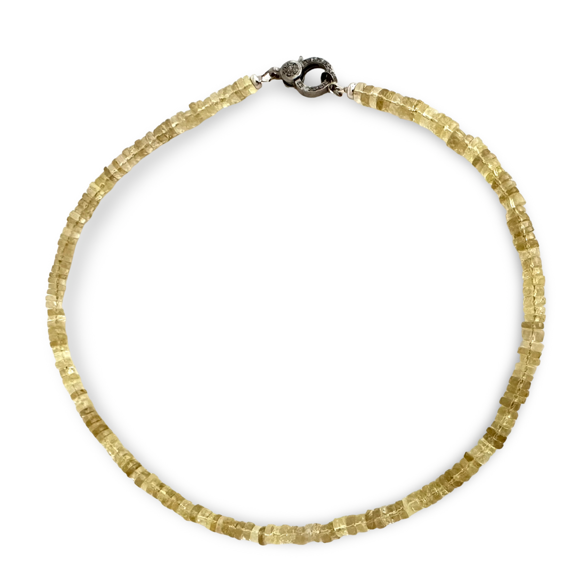 A beaded necklace made of faceted, translucent pale yellow lemon beads, arranged in a circle on a solid white background. It features a dark metal clasp at the top.