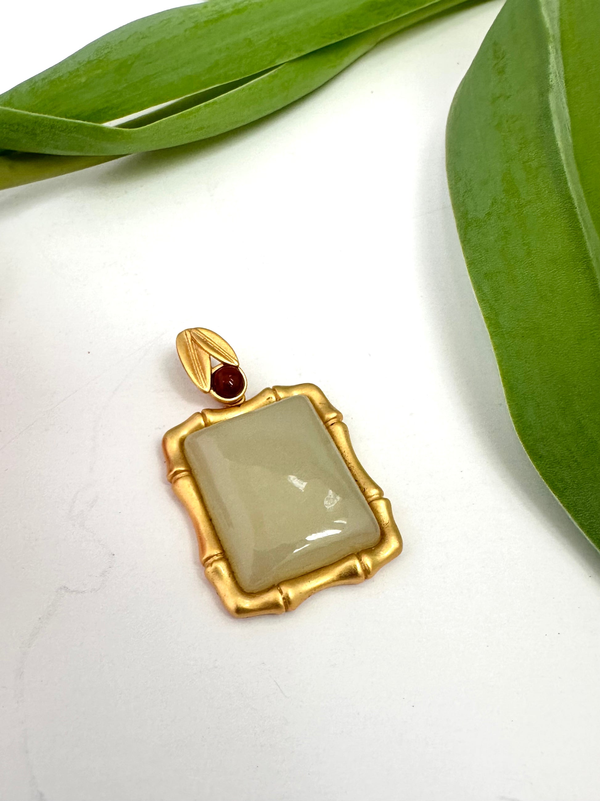 Light green jade bamboo-style pendant with red agate accent in gold vermeil