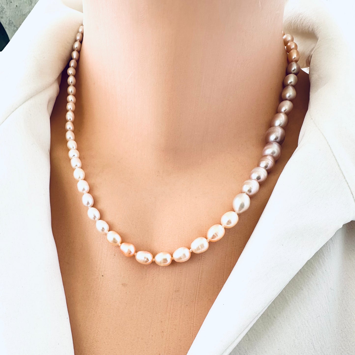 Rice Pearl Necklace with pastel freshwater pearls and silver tulip clasp displayed on mannequin.