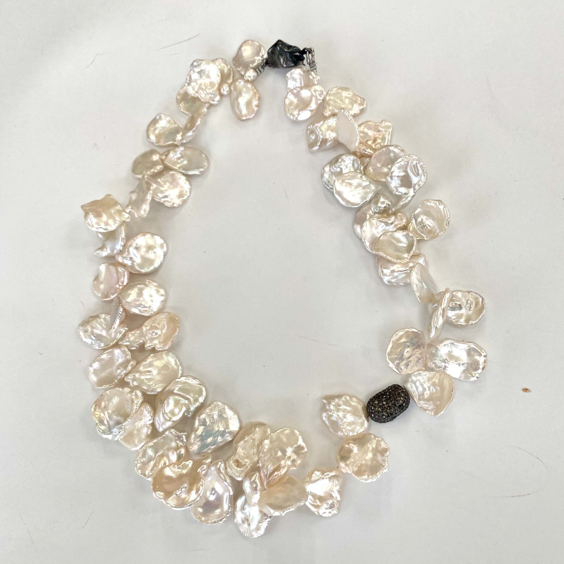 Bridal Petal Pearl Necklace featuring luminous freshwater keshi pearls in oxidized silver and pavé diamond design.