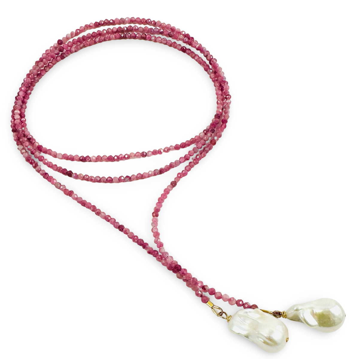 A beaded mala necklace featuring multiple strands of faceted pinkish-red beads, two large white baroque pearls, and small gold-toned spacer rings, displayed on a clean white background.