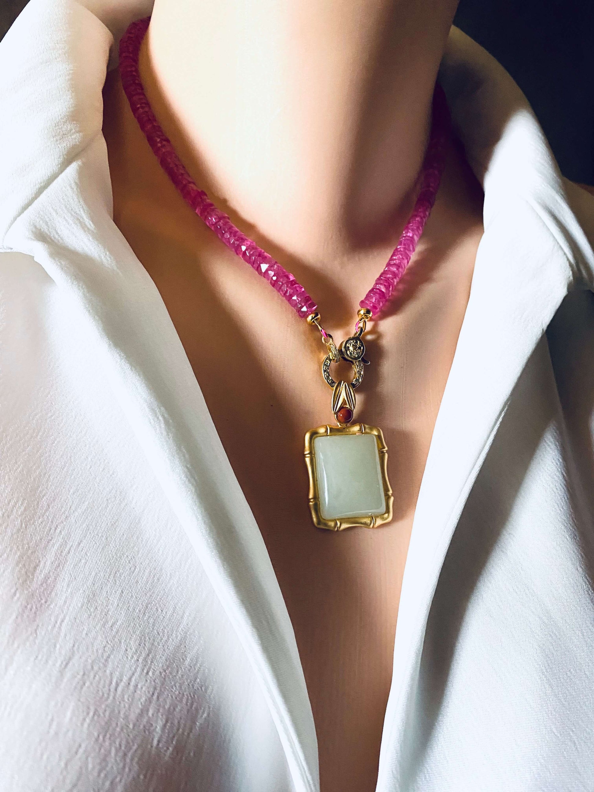Pink topaz beaded necklace with gold vermeil pavé clasp worn on a model's neck, showcasing vibrant color and elegance.