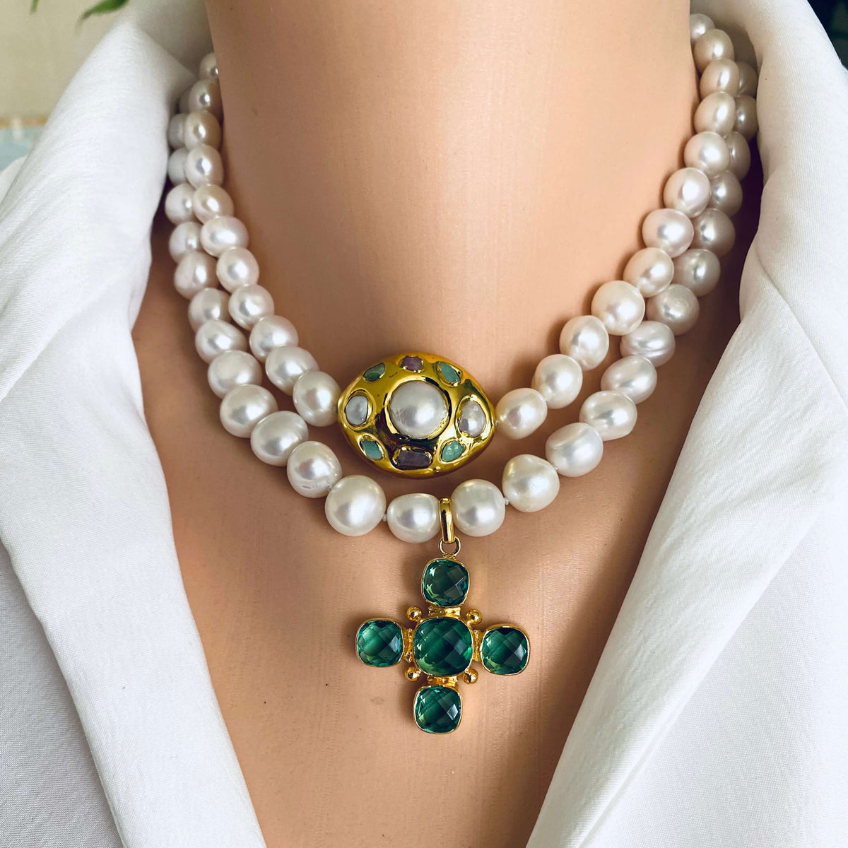 Potato pearl necklace with cross pendant featuring green quartz and golden accents, showcasing timeless elegance.