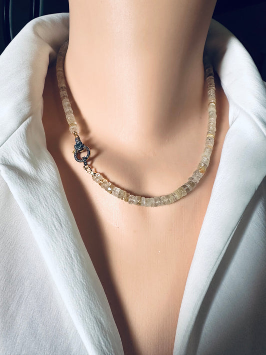 RUTILATED QUARTZ Necklace on a mannequin wearing a white outfit