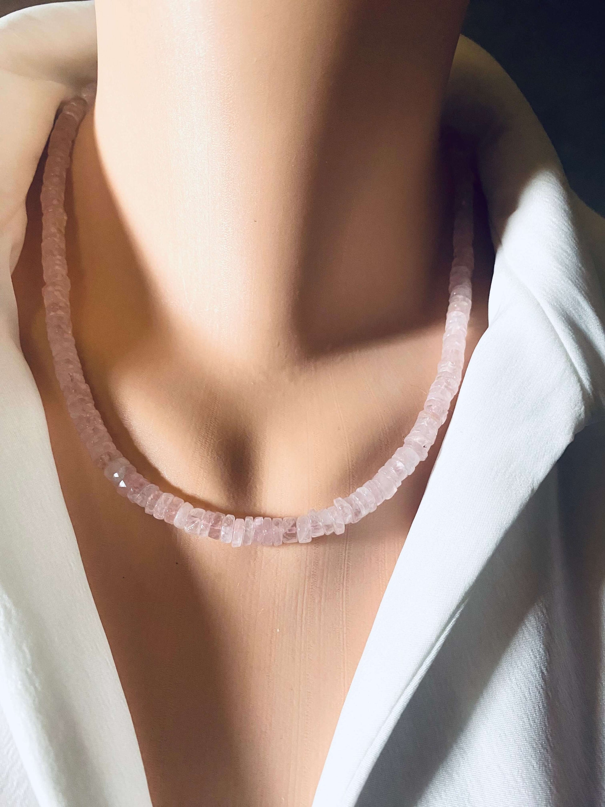 Rose quartz beaded necklace displayed on a mannequin's neck, showcasing its natural beauty and elegance.