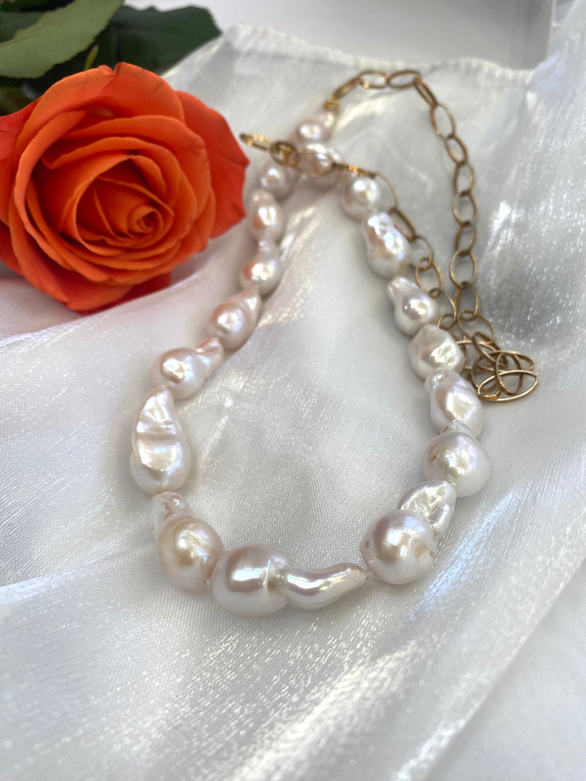 Close-up of baroque pearl gold chain necklace on white background — detailed view of chunky gold chain and lustrous pearls by Loulia Pearl Jewelry