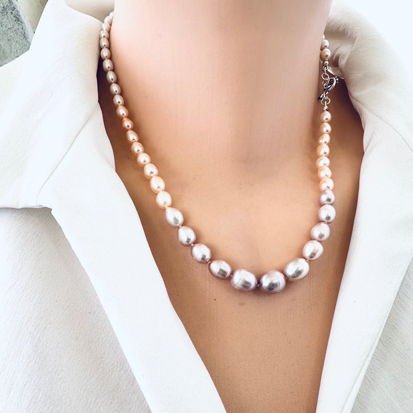 Rice Pearl Necklace with silver tulip toggle clasp and pastel pearls displayed on mannequin front view.