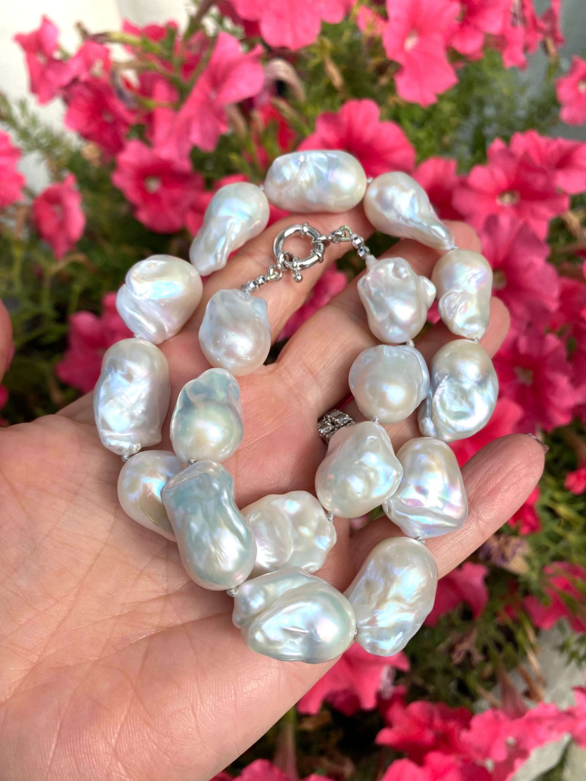 Baroque Pearl Chunky Necklace displayed in hand, featuring unique white freshwater pearls on soft grey silk thread.