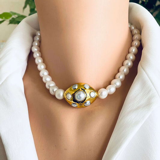 White potato pearl necklace with gold focal accent showcased on a mannequin bust.