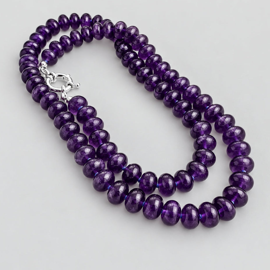 Amethyst beaded necklace with sterling silver clasp displayed on white background