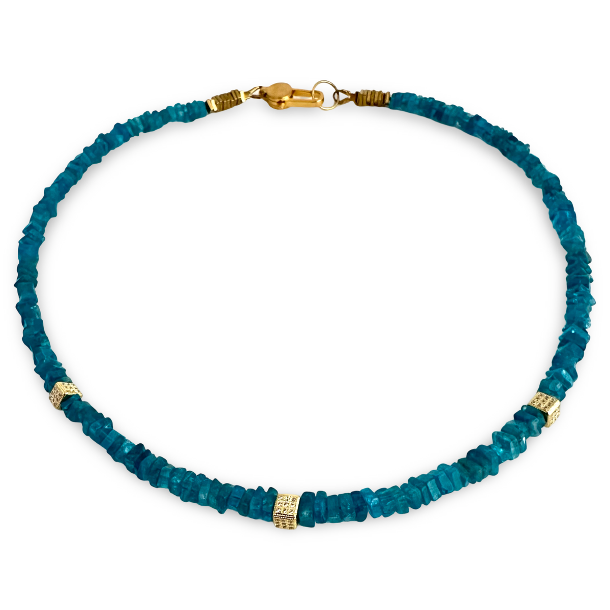 A beaded necklace made of faceted teal-blue gemstone chips with small gold spacer beads and a gold clasp, shown on a plain white background.