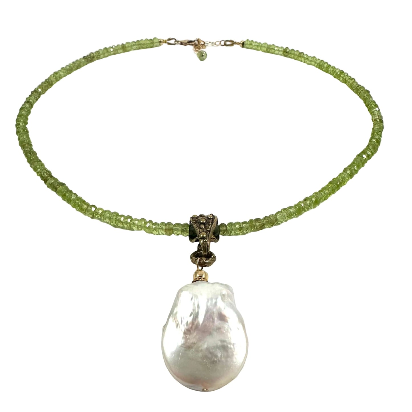 A beaded necklace featuring a strand of light green faceted beads, a bronze-toned central connector, and a large, irregular white baroque pearl pendant, displayed on a clean white background.