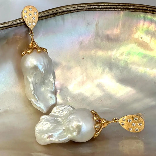 Close-up of Baroque Pearl Gold Vermeil Earrings on white pearl backdrop — handcrafted statement jewelry by Loulia Pearl Jewelry