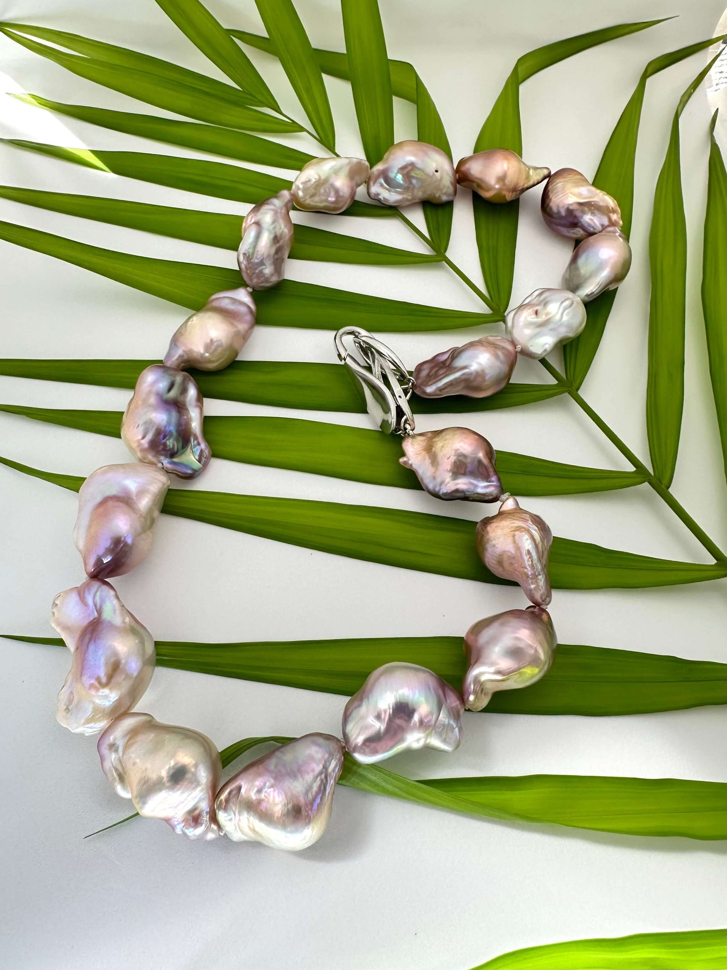 Pearl necklace on a green leaf