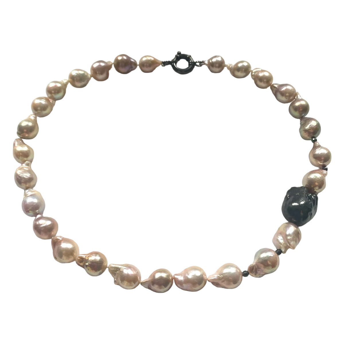 A baroque pearl necklace with irregular, teardrop-shaped pearls in shades of champagne, beige, and soft pink, featuring a dark black clasp and a single prominent dark polished bead.