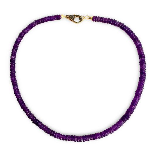 A beaded necklace made of small, faceted purple gemstone beads, featuring a gold-toned lobster clasp at the top, displayed on a clean white background.