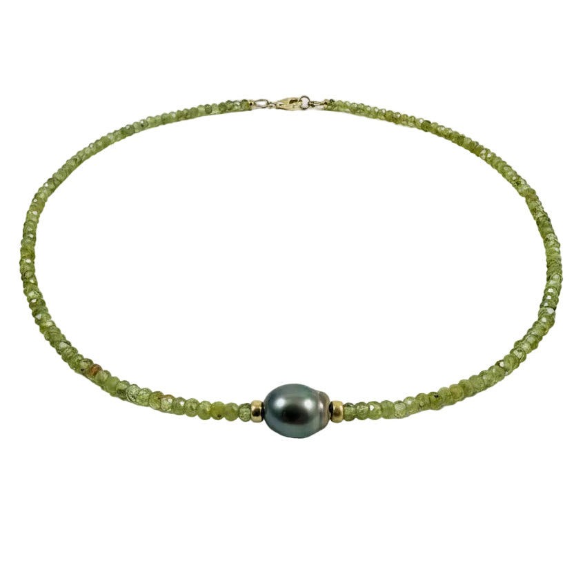 A beaded necklace made of light green peridot beads with a central Tahitian pearl and small gold spacer beads, displayed on a light gray background with text reading 'Peridot+Tahitian Pearl' below.