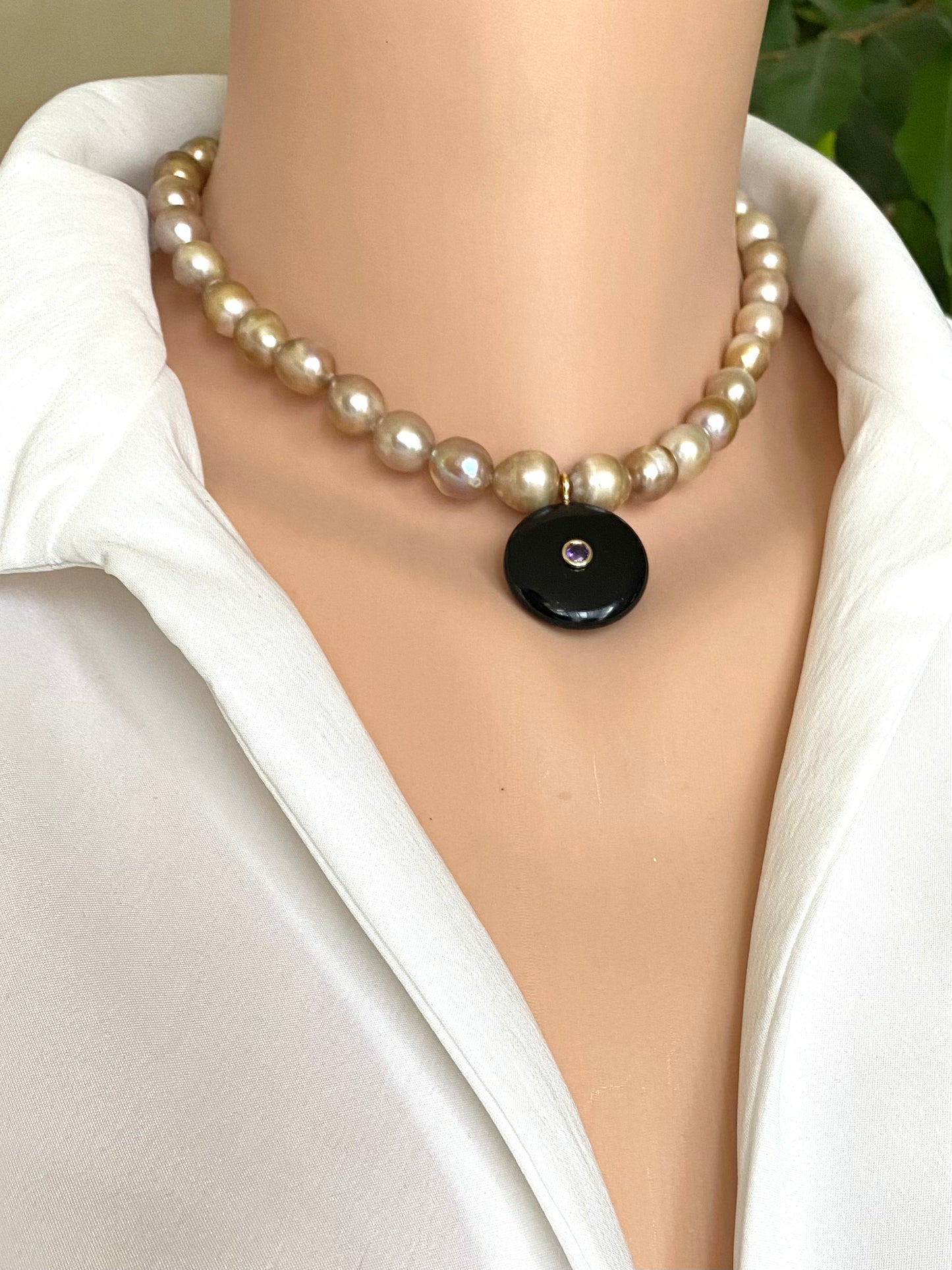 golden green 10m rice pearl choker necklace holding black obsidian pendant