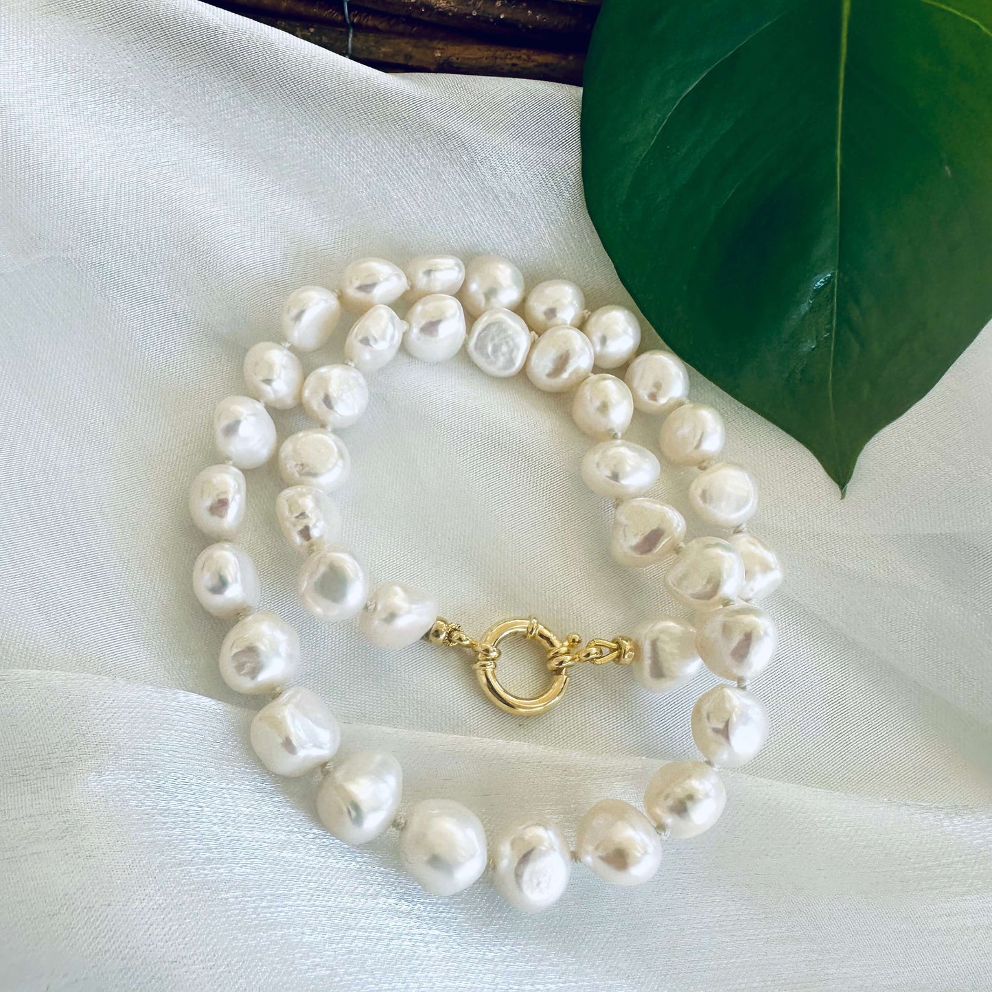 Small baroque pearl classic necklace featuring natural freshwater pearls with unique shapes and a gold clasp.