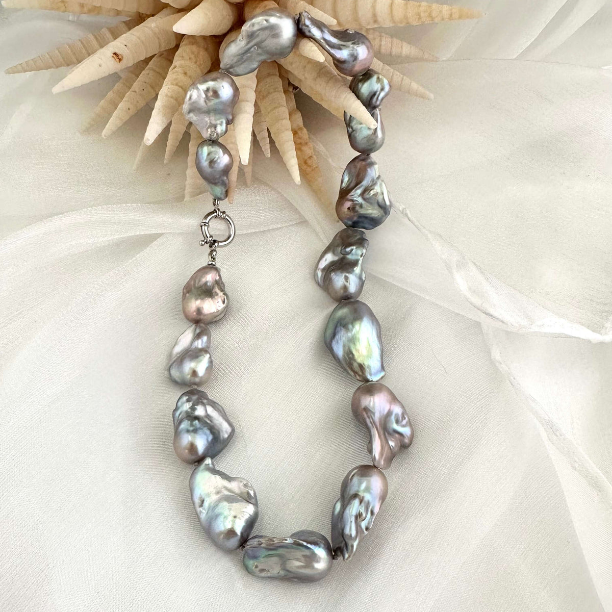 Baroque pearl necklace with silver details, handmade in Canada, featuring iridescent baroque pearls in organic shapes.