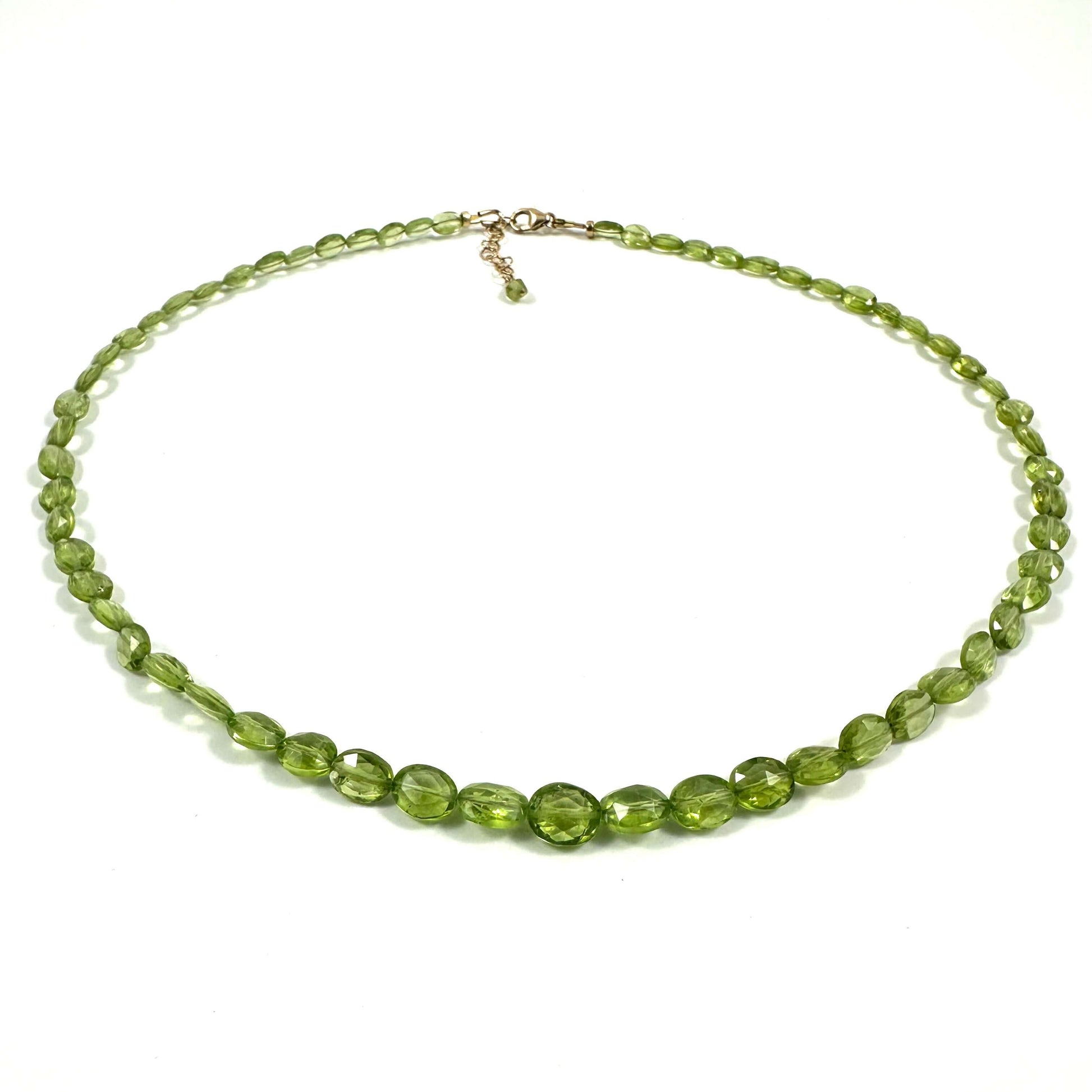 A beaded necklace made of faceted olive green beads with a small gold-tone clasp, displayed on a clean white background.