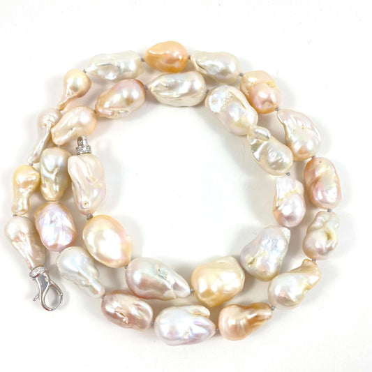 Hand knotted with large freshwater baroque pearls in natural shades of white, ivory, beige and soft blush, this 29-inch necklace brings together dramatic size and effortless versatility.