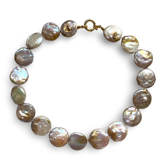 A strand of baroque freshwater pearls in muted olive, gray, and bronze tones, arranged in a circle with a gold clasp on a white background.