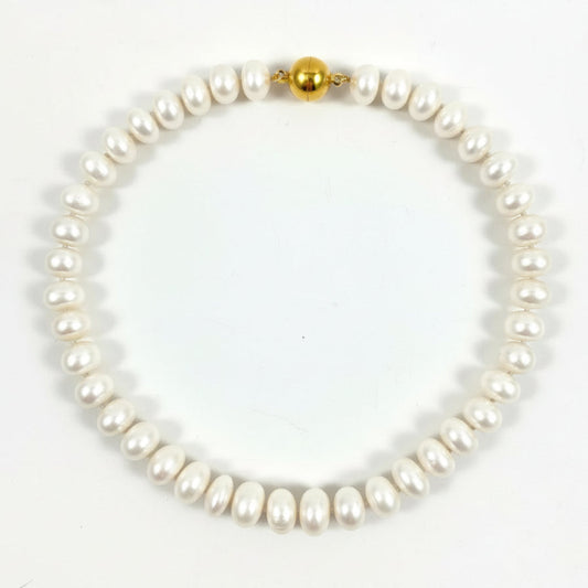 A single-strand baroque pearl necklace with a polished gold bead clasp, displayed on a clean white background.