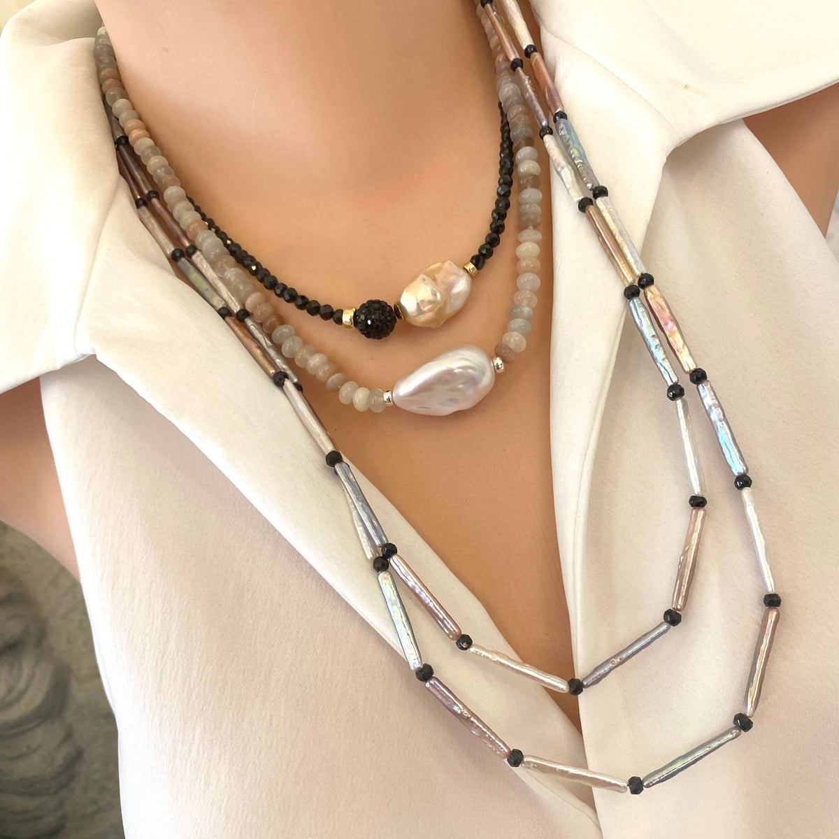 Pastel Stick Pearl Necklace showcasing stick pearls and black spinel beads on a model, handcrafted design in elegant colors.