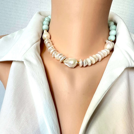 A close-up of a model wearing a double-strand statement necklace. The necklace features a strand of irregular, baroque-style cream pearls and a second strand of smooth, pale mint green beads, separated by small gold spacer rings.