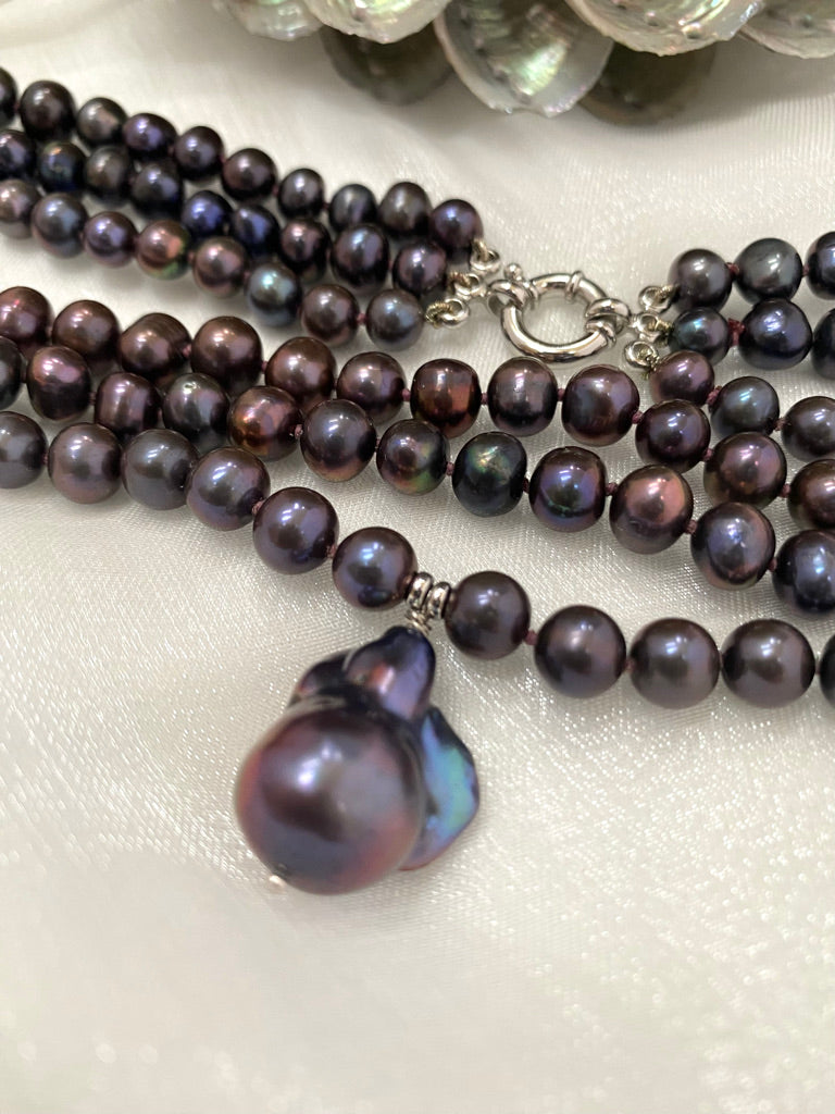 Close-up of a multi-strand pearl necklace on a white background