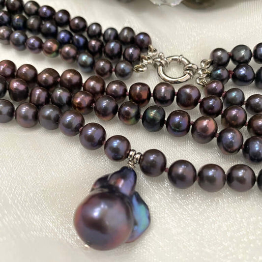Close-up of a multi-strand pearl necklace on a white background