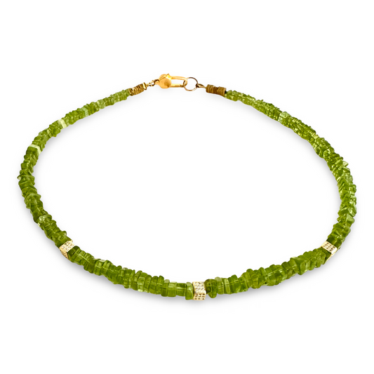 A green faceted gemstone beaded necklace with gold-toned spacer beads and a gold clasp, displayed on a clean white background.