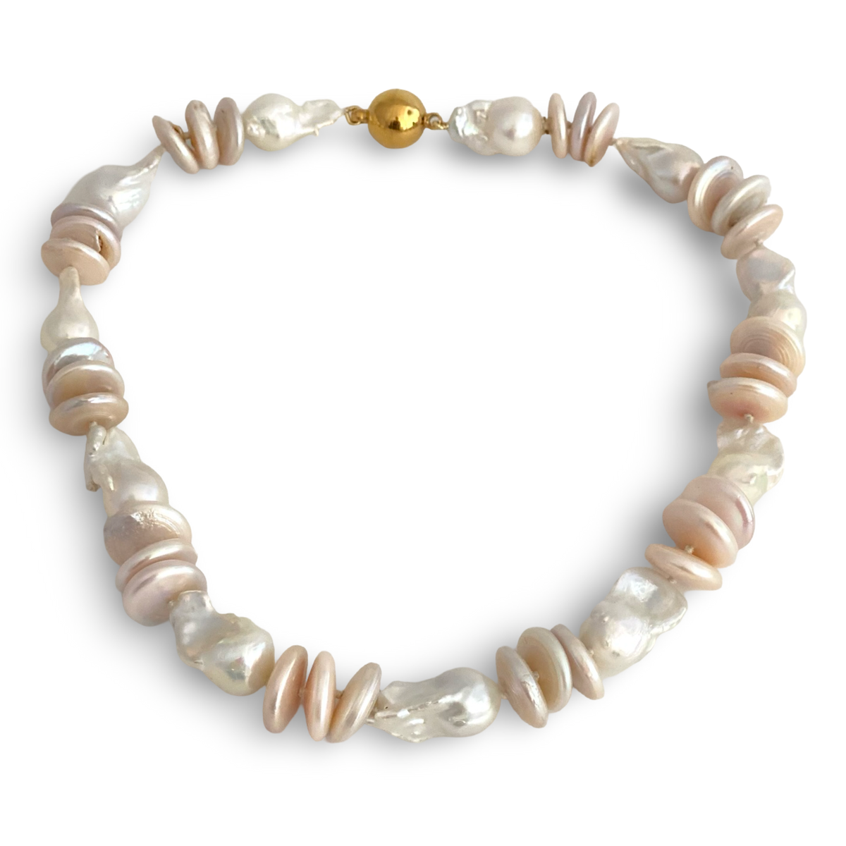 large pink coin pearls with dramatic white baroque pearls, creating a beautiful contrast of soft color, organic shape, and generous scale.