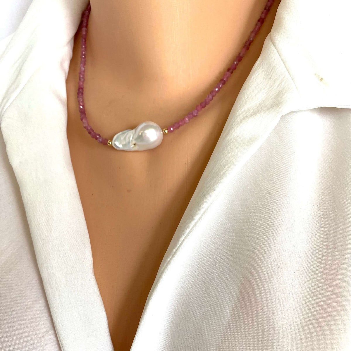 Pink Tourmaline Baroque Pearl Necklace on model, featuring pink tourmaline beads and a baroque pearl centerpiece.