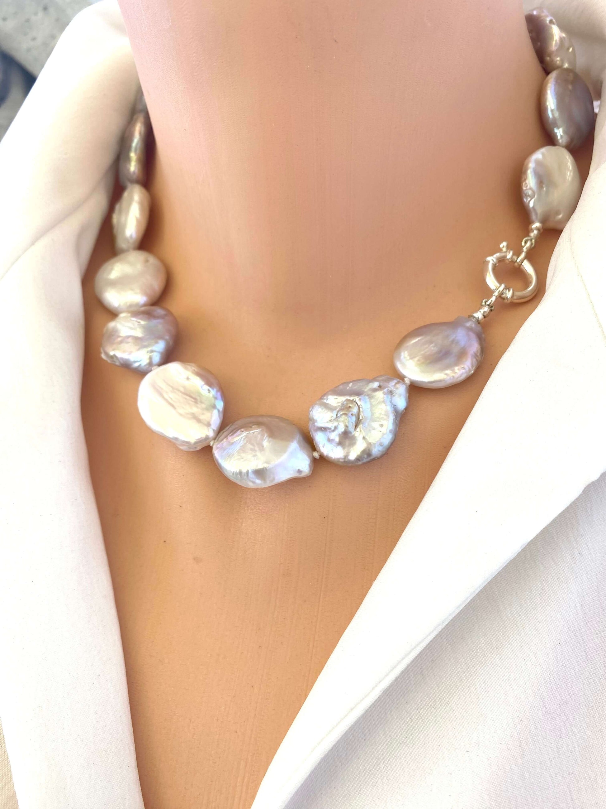 Side view of large coin pearl necklace on mannequin, handmade statement jewelry