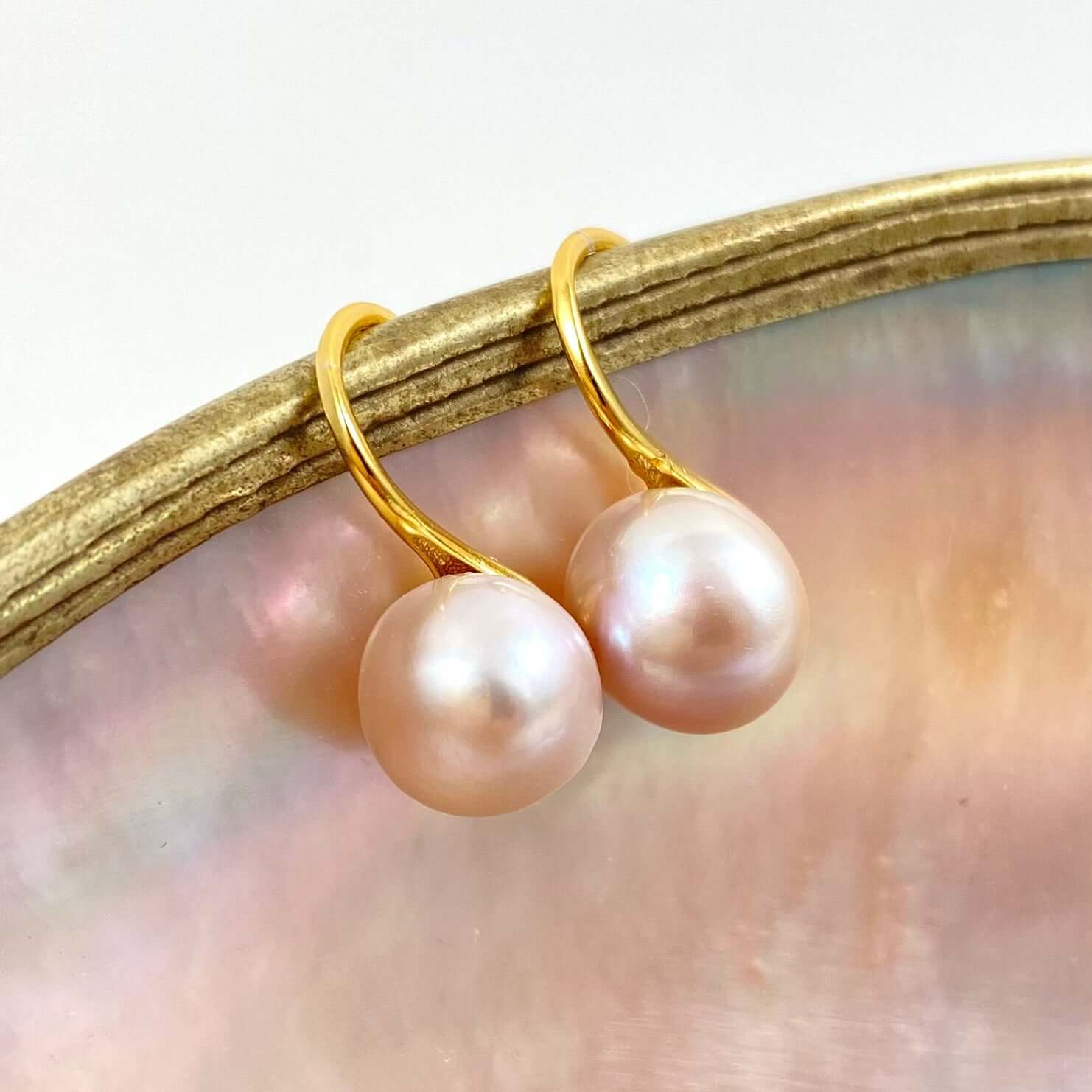 small and soft pink pearl earrings, gold settings