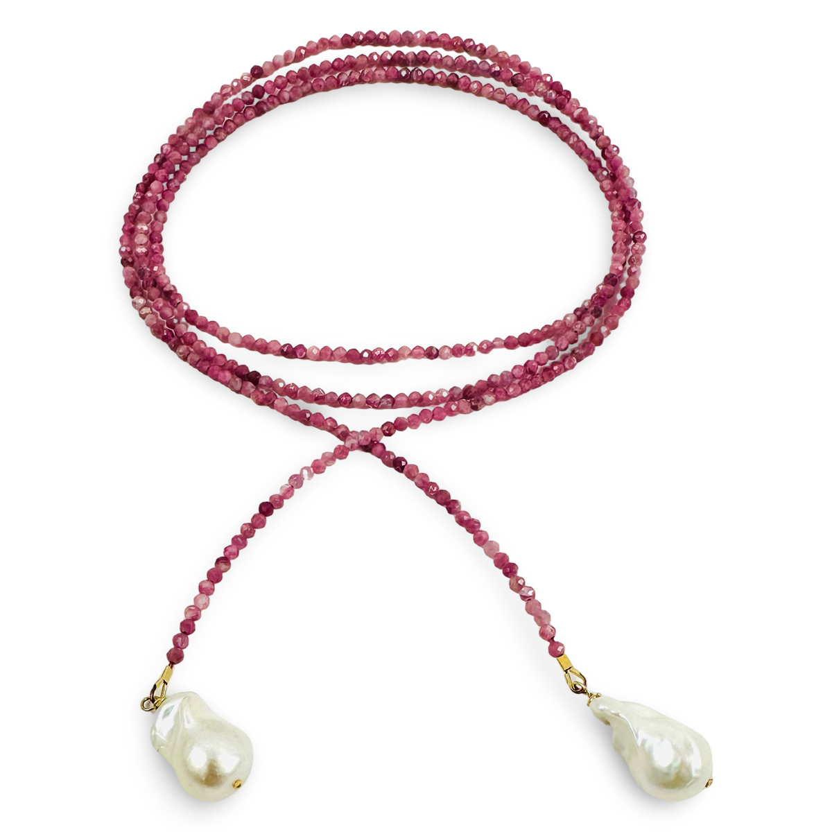 A long-strand beaded necklace featuring dark pinkish-red beads and two large, irregular white baroque pearls, accented with small gold-toned metal connectors, shown on a plain white background.