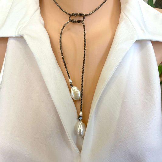 Hematite baroque pearl lariat necklace worn on model showing adjustable lariat styling