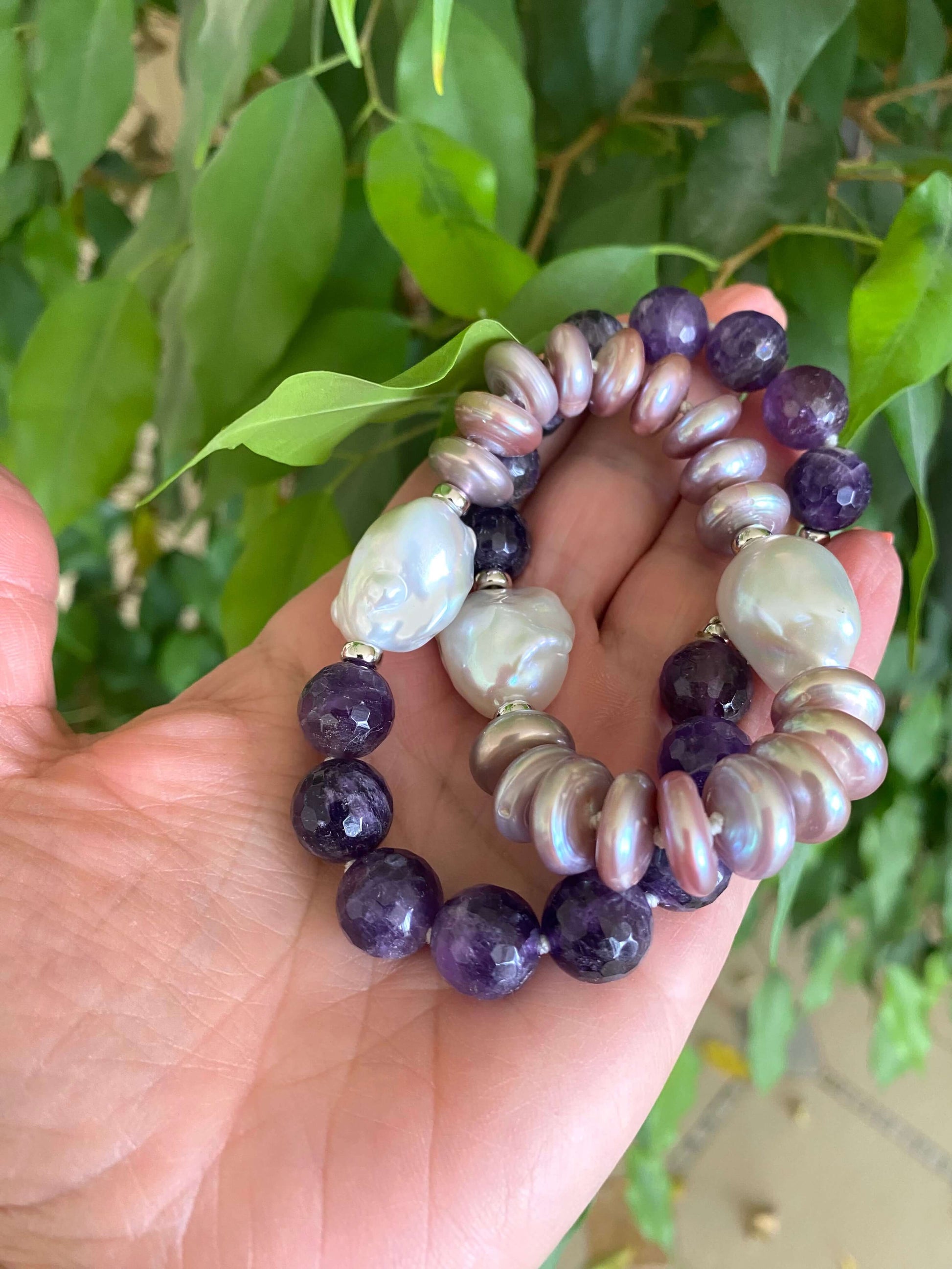 Amethyst pearl necklace featuring large white baroque pearls and deep purple amethyst beads.