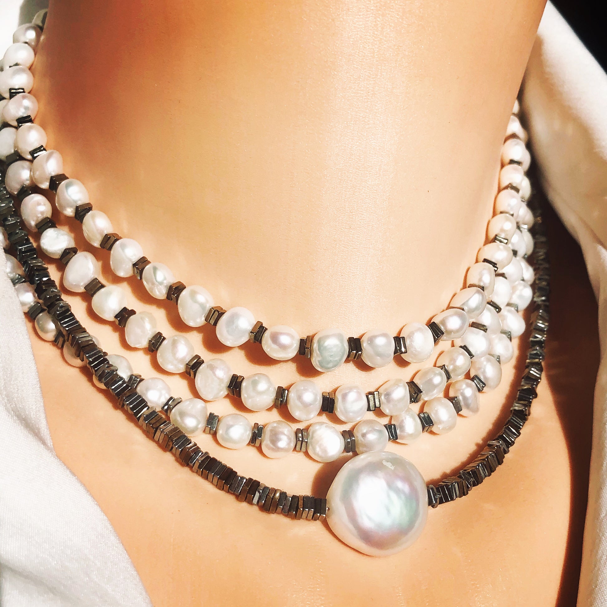 Pearl hematite choker necklace worn layered with pearls and hematite beads
