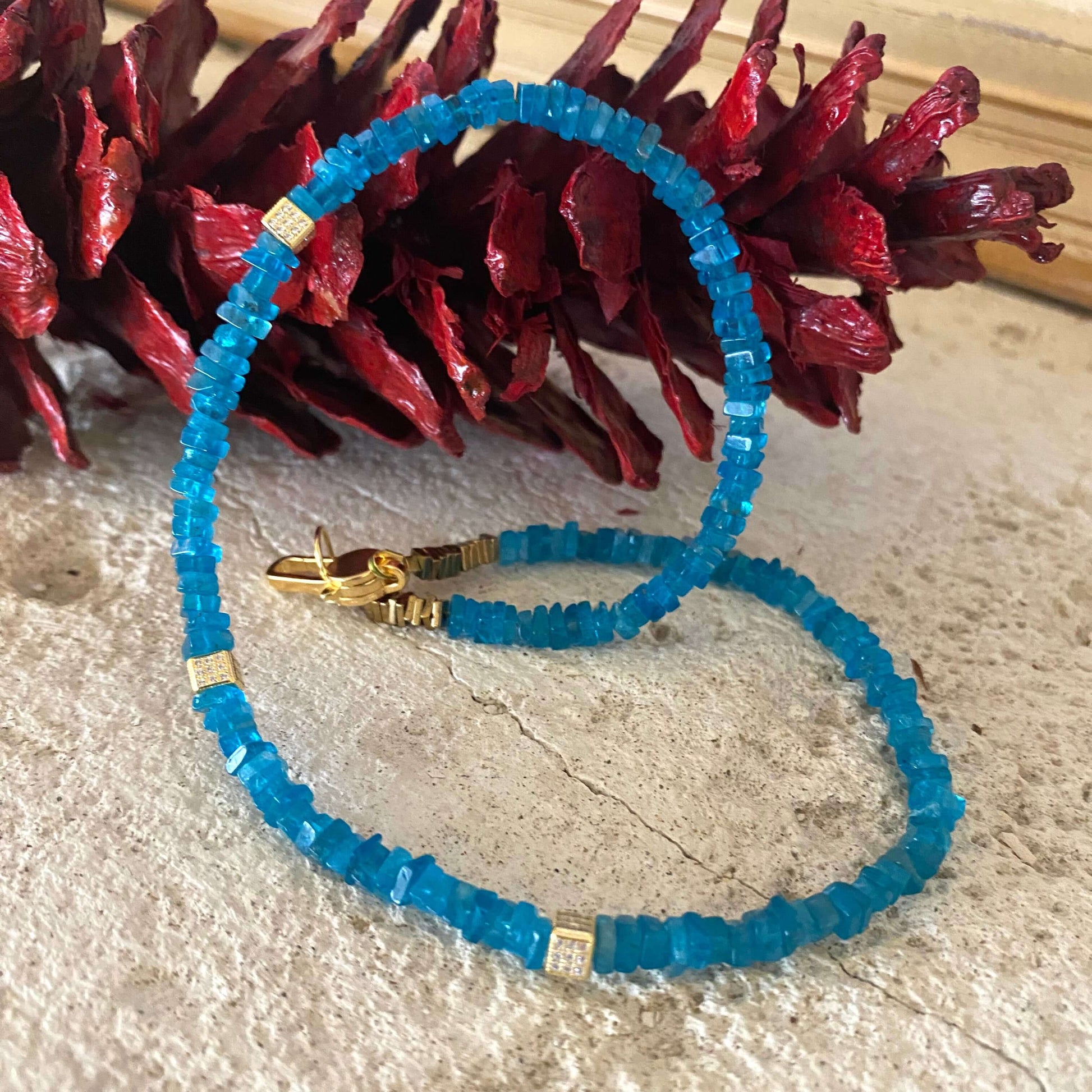Blue Apatite Choker Necklace with Faceted Beads showcasing vibrant blue beads and elegant gold accents.