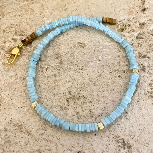 Blue Opal Choker Necklace with Peruvian Opal Beads showcased on a textured stone surface.